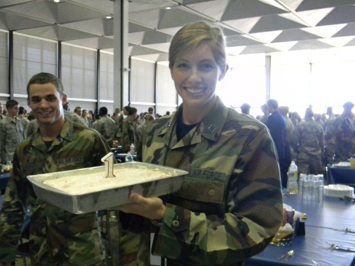 military cadet holds son's birthday cake